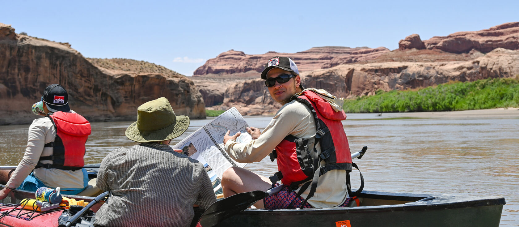 Gap Semester student reading a map while canoeing.