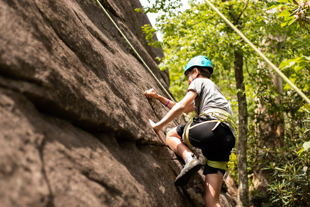 Teen rock climbing in the White Mountains.