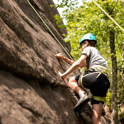 Teen rock climbing in the White Mountains.