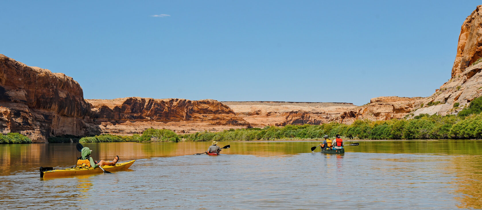 People canoeing down Labyrinth Canyon on their Gap Semester.
