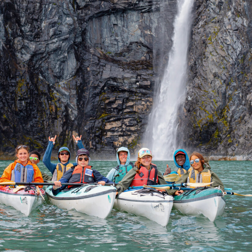 Group of high school students sea kayaking in the Prince William Sound of Alaska.