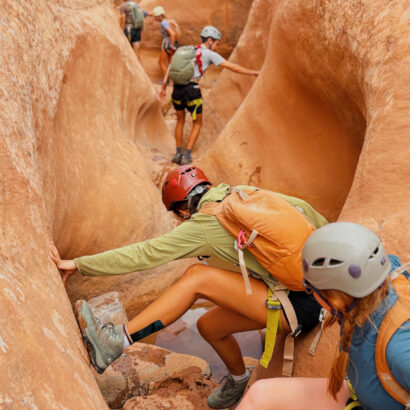 High school students canyoneering in slot canyons of Southern Utah.