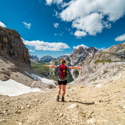 High school girl hiking in the Italian Dolomites on a summer adventure.
