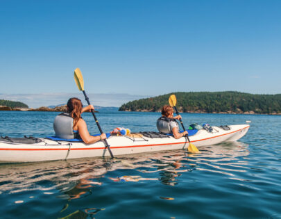 people in a kayak in the Puget Sound exploring the waters.