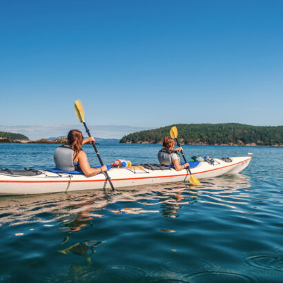 people in a kayak in the Puget Sound exploring the waters.