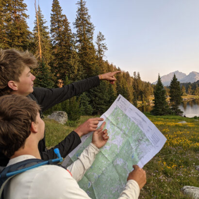 Two high school boys reading a map in the Wind River Range of Wyoming.