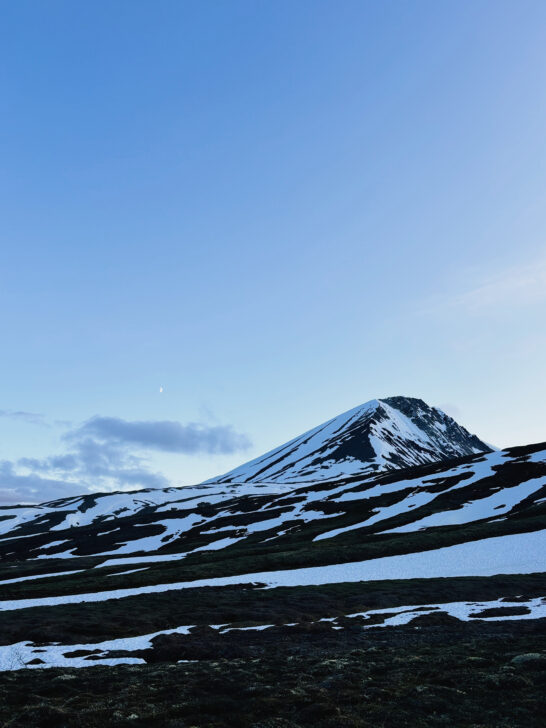The moon and aplineglow over a peak in Gates of the Arctic National Park.