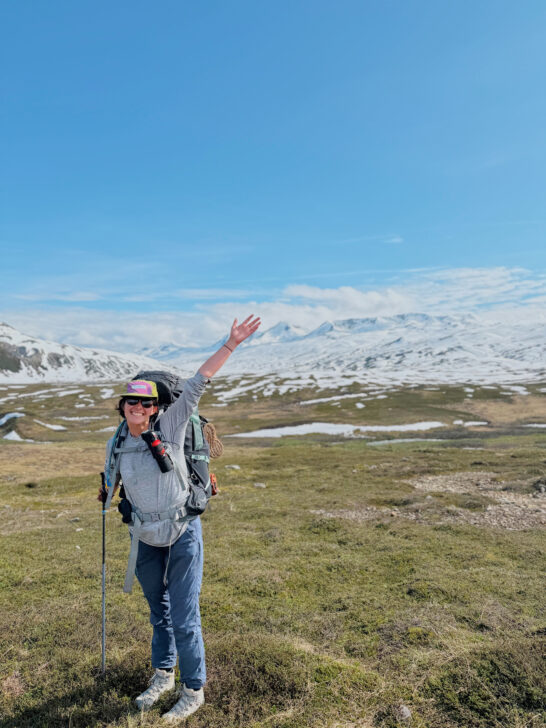 Person backpacking in the remote alaskan wilderness.