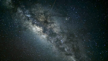 A view of the milky way with a shooting star.