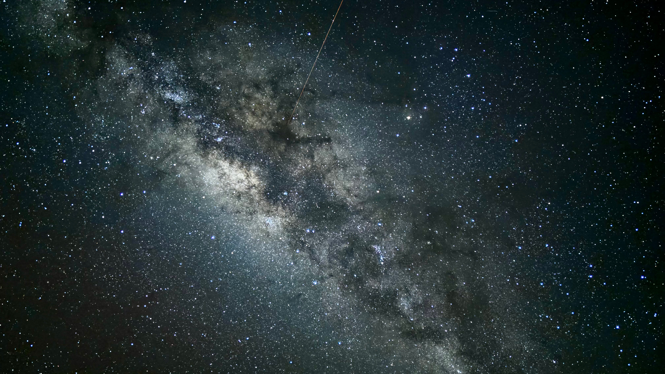 A view of the milky way with a shooting star.