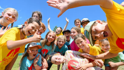 Group of Base Campers with thumbs up and smiling faces.