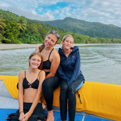 Three high school girls on a boat on the ocean in Australia.